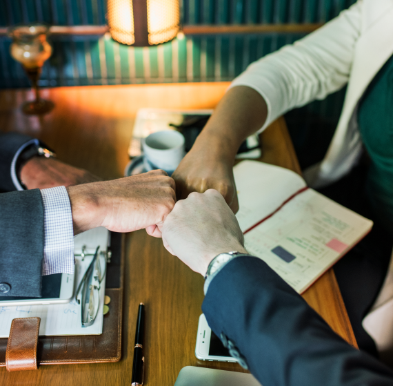 A handshake at a business meeting in a cafe